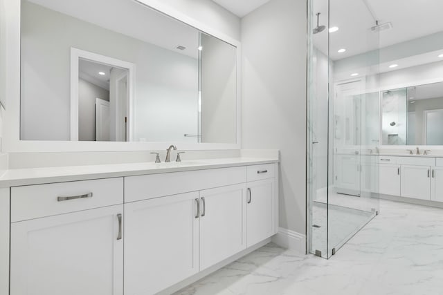 full bath with marble finish floor, a marble finish shower, visible vents, and a sink