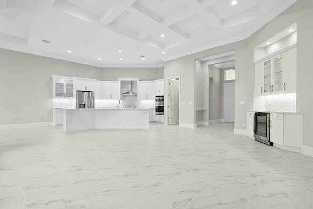 unfurnished living room with beverage cooler, marble finish floor, a high ceiling, and coffered ceiling