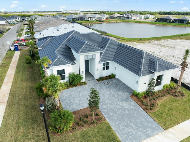 birds eye view of property featuring a residential view and a water view