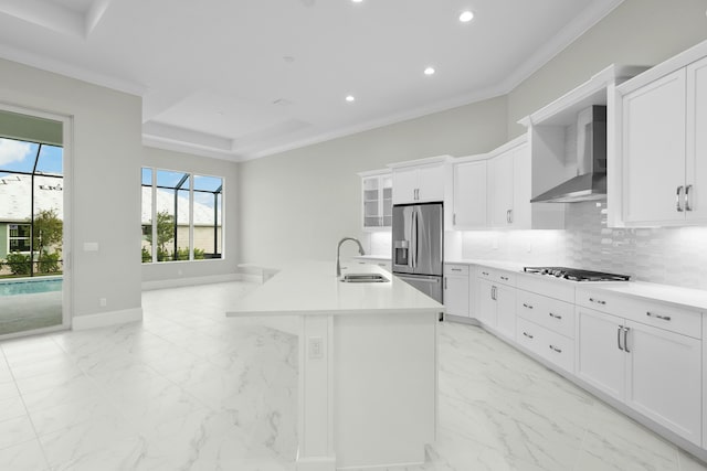 kitchen with wall chimney range hood, marble finish floor, stainless steel refrigerator with ice dispenser, and a sink