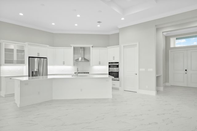 kitchen featuring appliances with stainless steel finishes, marble finish floor, light countertops, and wall chimney range hood