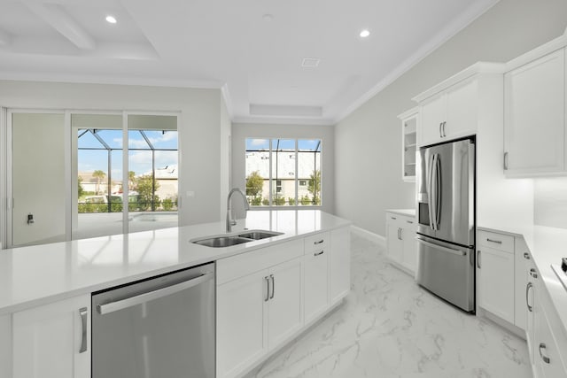 kitchen featuring marble finish floor, stainless steel appliances, a tray ceiling, and light countertops