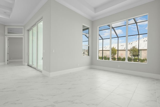 spare room featuring a tray ceiling, marble finish floor, and baseboards