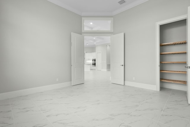 unfurnished bedroom featuring marble finish floor, baseboards, visible vents, and ornamental molding