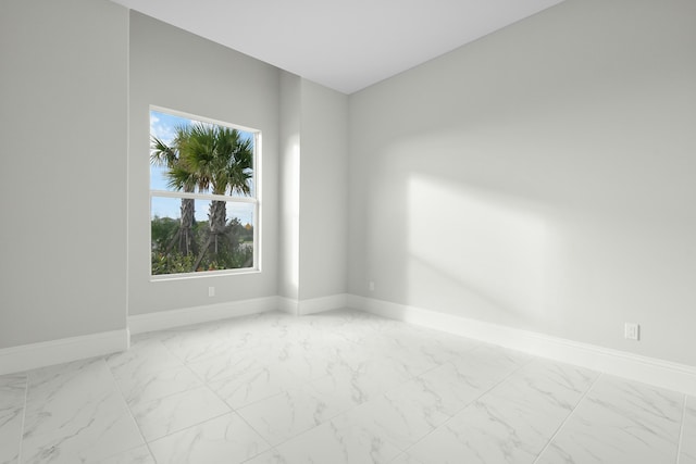 empty room with marble finish floor and baseboards