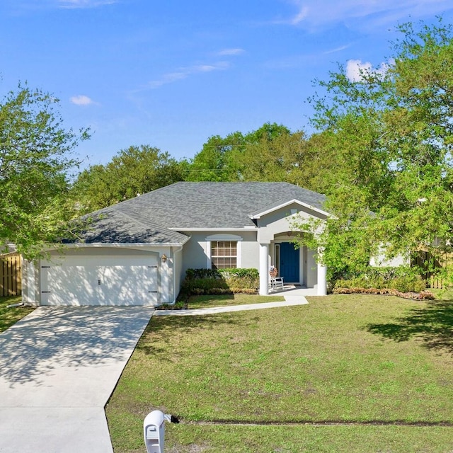 view of front of house with roof with shingles, an attached garage, stucco siding, a front lawn, and concrete driveway