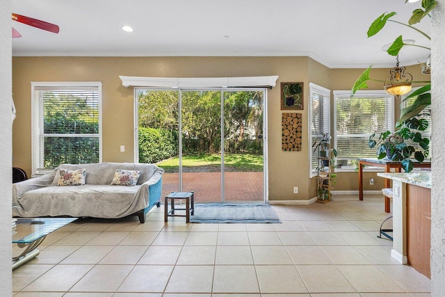 living room with light tile patterned floors, plenty of natural light, and ornamental molding