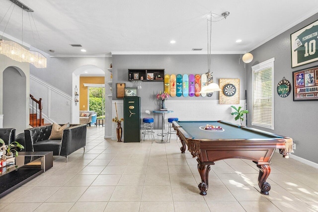 playroom with ornamental molding, arched walkways, plenty of natural light, and tile patterned floors