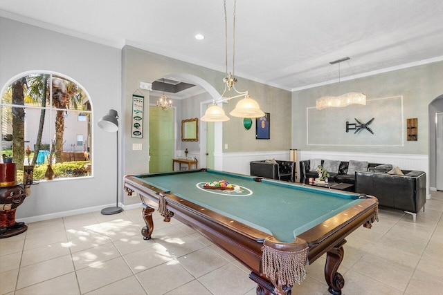 recreation room featuring light tile patterned floors, visible vents, arched walkways, and ornamental molding