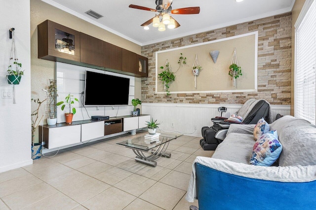 living room with ornamental molding, visible vents, ceiling fan, and light tile patterned floors