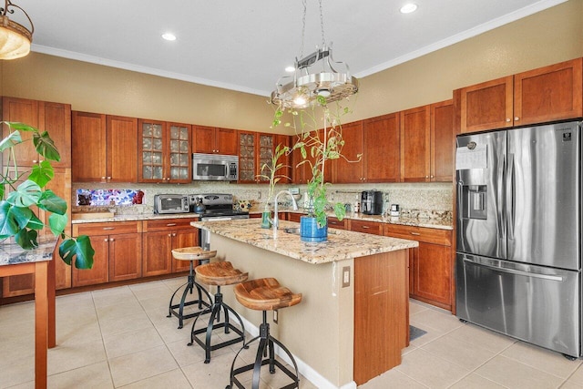 kitchen with light tile patterned floors, brown cabinetry, appliances with stainless steel finishes, ornamental molding, and backsplash