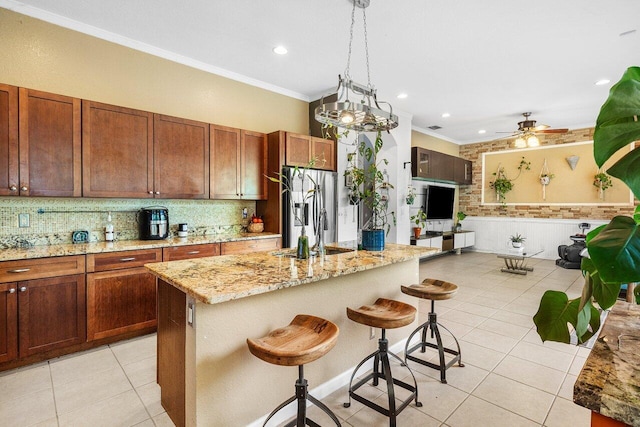 kitchen featuring crown molding, tasteful backsplash, light tile patterned floors, and stainless steel fridge with ice dispenser