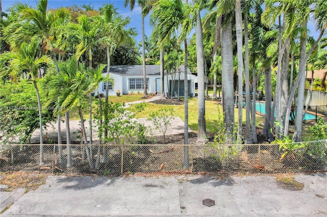 view of front of home with a fenced front yard and a garage