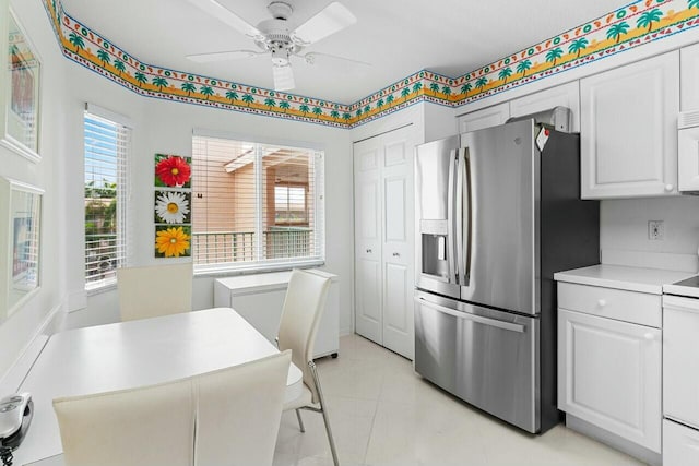 kitchen with light tile patterned flooring, white appliances, a ceiling fan, white cabinets, and light countertops