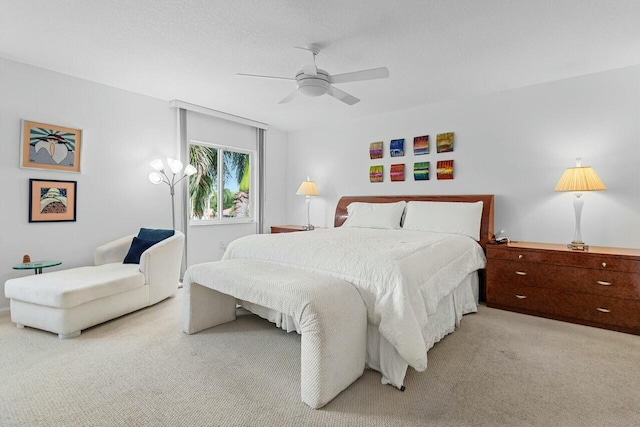 bedroom featuring light carpet and ceiling fan