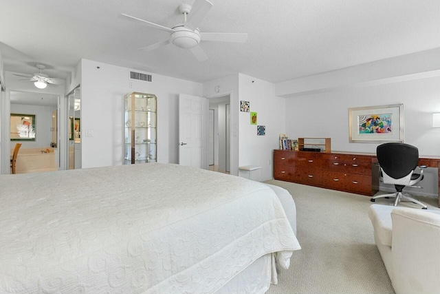 carpeted bedroom featuring ceiling fan and visible vents