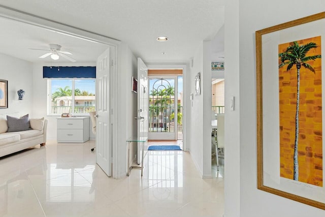 doorway to outside with light tile patterned floors, ceiling fan, baseboards, and recessed lighting