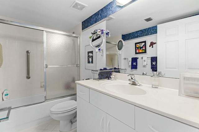 full bath with visible vents, toilet, tile patterned floors, combined bath / shower with glass door, and vanity