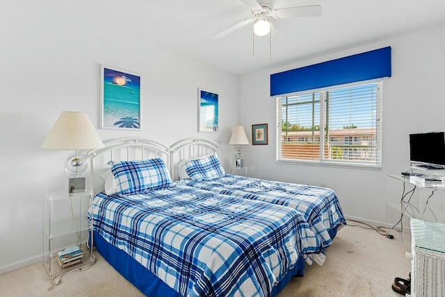 carpeted bedroom with a ceiling fan and baseboards