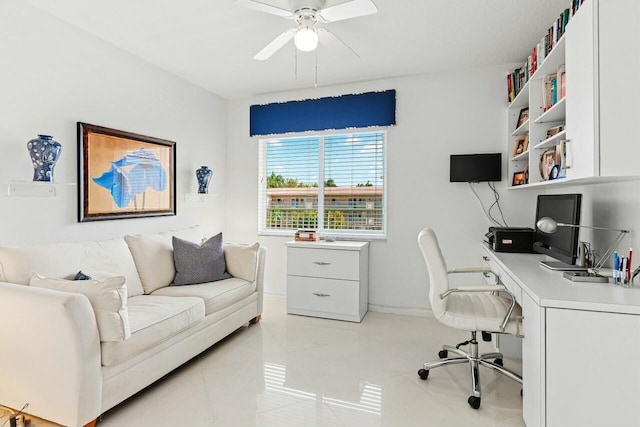 home office with light tile patterned floors, ceiling fan, and baseboards