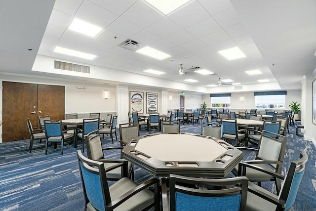 carpeted dining room featuring a drop ceiling and visible vents