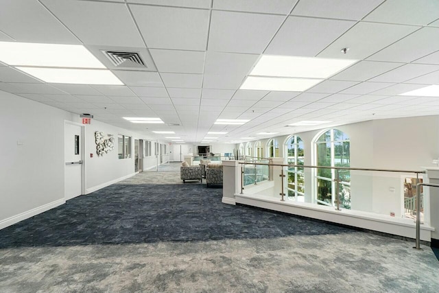 interior space with carpet, visible vents, a drop ceiling, and baseboards