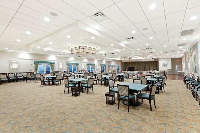 carpeted dining room featuring visible vents, a tray ceiling, and recessed lighting