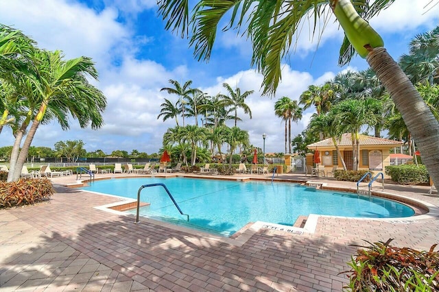 pool featuring a patio area and fence