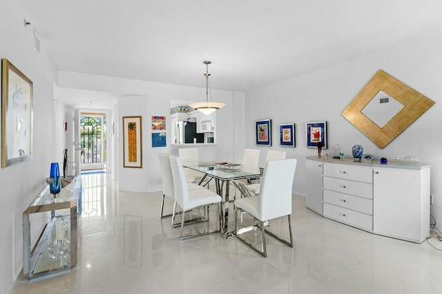 dining room featuring marble finish floor and visible vents