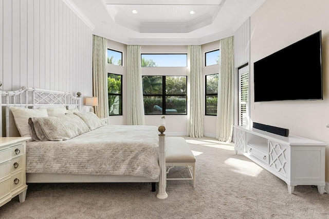 carpeted bedroom with a tray ceiling, ornamental molding, a high ceiling, and recessed lighting