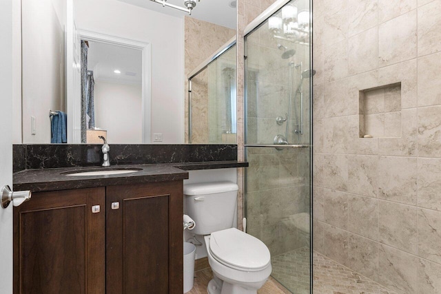 full bath with toilet, a shower stall, and vanity