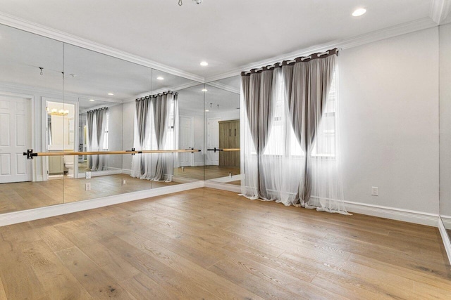 unfurnished room featuring recessed lighting, ornamental molding, wood finished floors, a chandelier, and baseboards