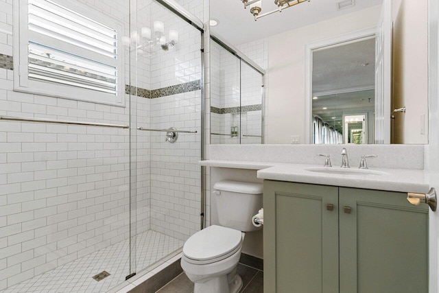 bathroom featuring visible vents, vanity, a shower stall, and toilet