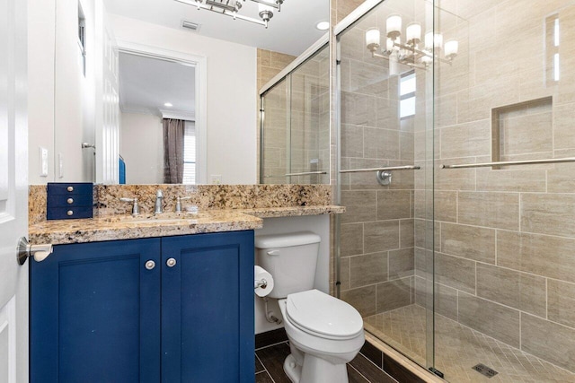 bathroom featuring toilet, a stall shower, visible vents, and vanity