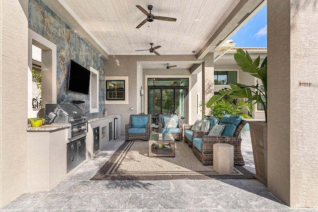 view of patio / terrace with a ceiling fan, an outdoor living space, exterior kitchen, and area for grilling