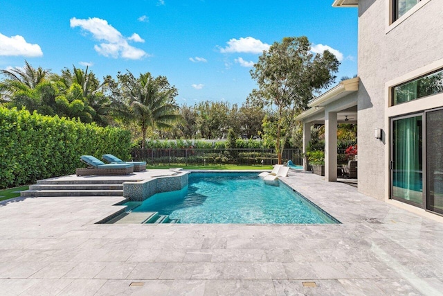 view of swimming pool with a ceiling fan, a fenced in pool, a patio area, and a fenced backyard