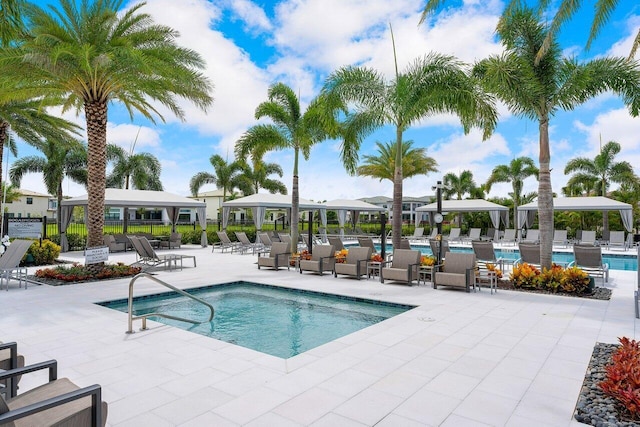 pool featuring a patio area, fence, and a gazebo