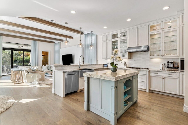 kitchen with dishwasher, open floor plan, wood finished floors, a peninsula, and under cabinet range hood