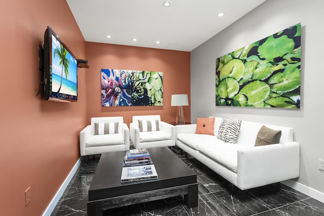 living area featuring baseboards, marble finish floor, and recessed lighting