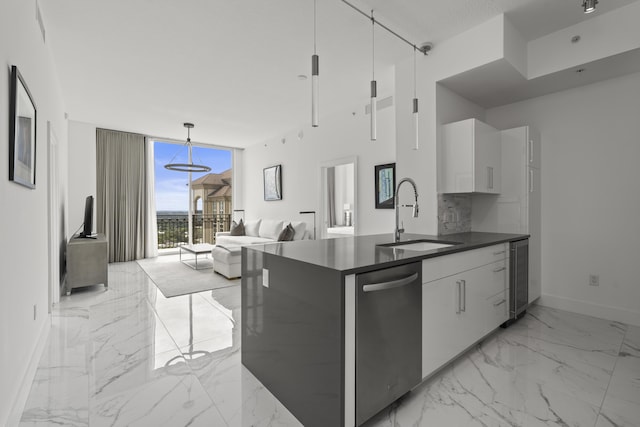 kitchen featuring dark countertops, modern cabinets, marble finish floor, floor to ceiling windows, and a sink