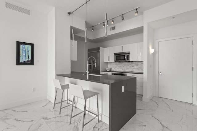 kitchen with dark countertops, visible vents, appliances with stainless steel finishes, and tasteful backsplash