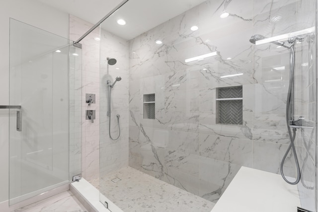 full bathroom with marble finish floor, a shower stall, and recessed lighting