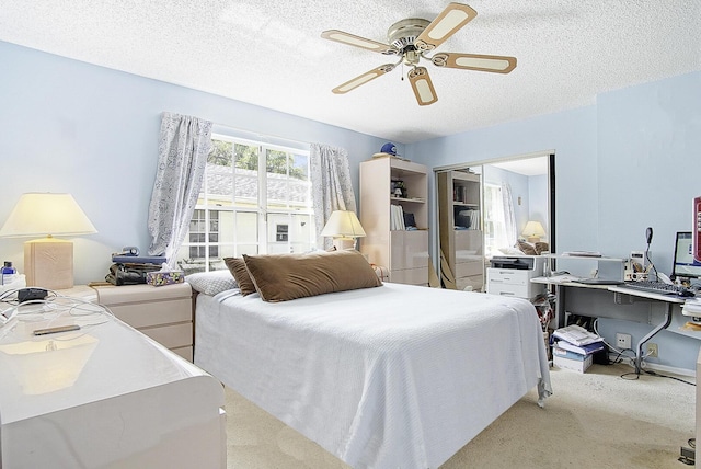 bedroom featuring carpet, a closet, ceiling fan, and a textured ceiling