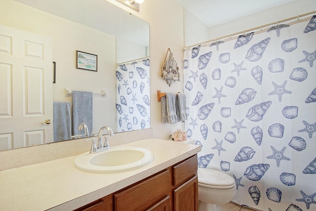 bathroom featuring toilet, a shower with curtain, and vanity