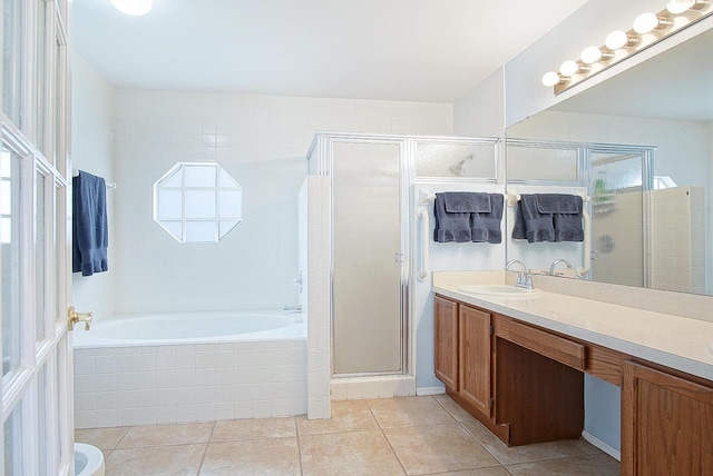 bathroom featuring a garden tub, a shower stall, vanity, and tile patterned floors