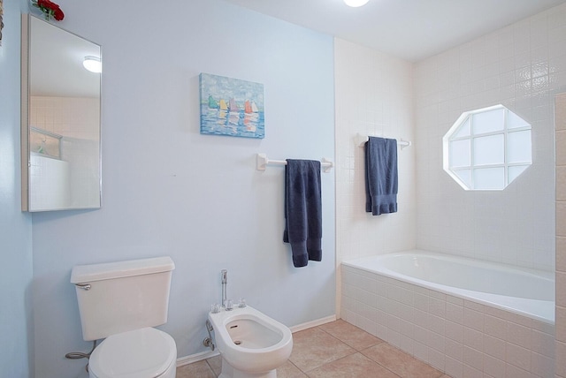 bathroom with baseboards, toilet, tile patterned flooring, tiled tub, and a bidet