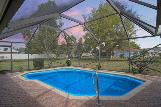 outdoor pool featuring a lanai and a lawn