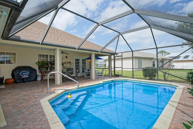 pool with a lanai, a grill, a patio, and french doors