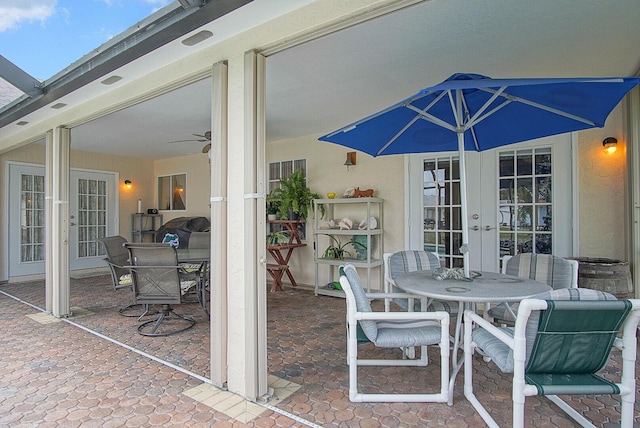 view of patio featuring ceiling fan, outdoor dining area, and french doors