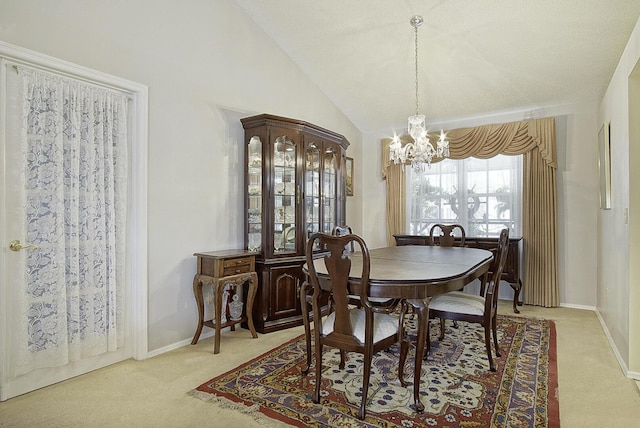 dining room featuring lofted ceiling, baseboards, light carpet, and a chandelier